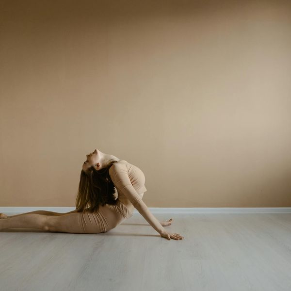 Person stretching gracefully, demonstrating improved flexibility and body awareness.